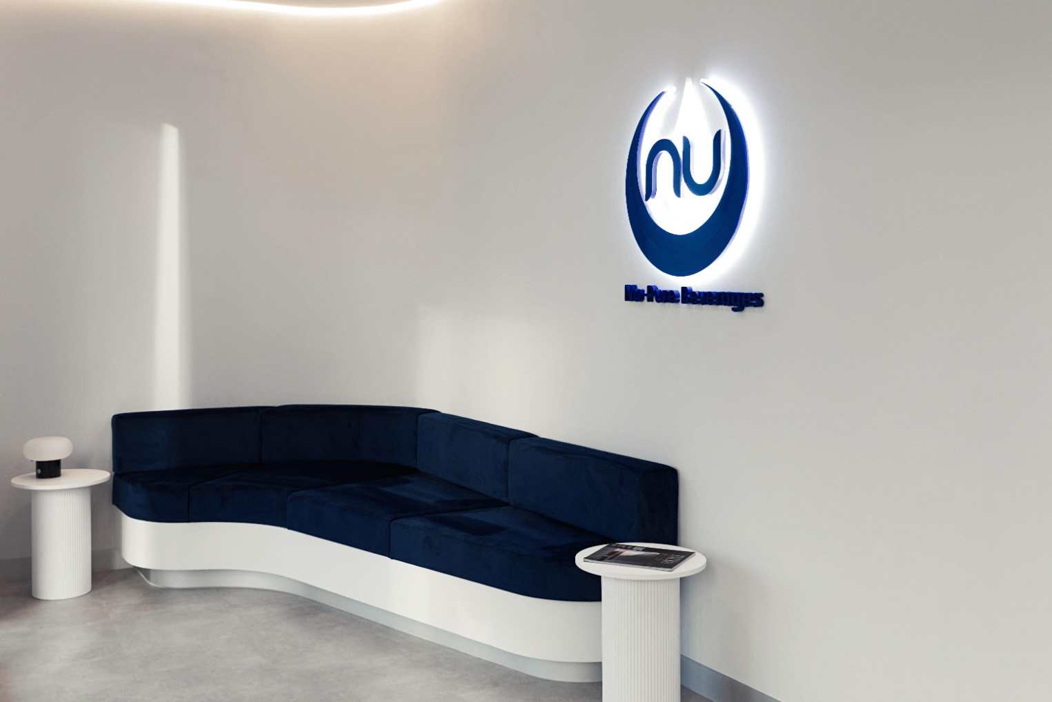 white curved wall with white curved bench seat and blue cushion