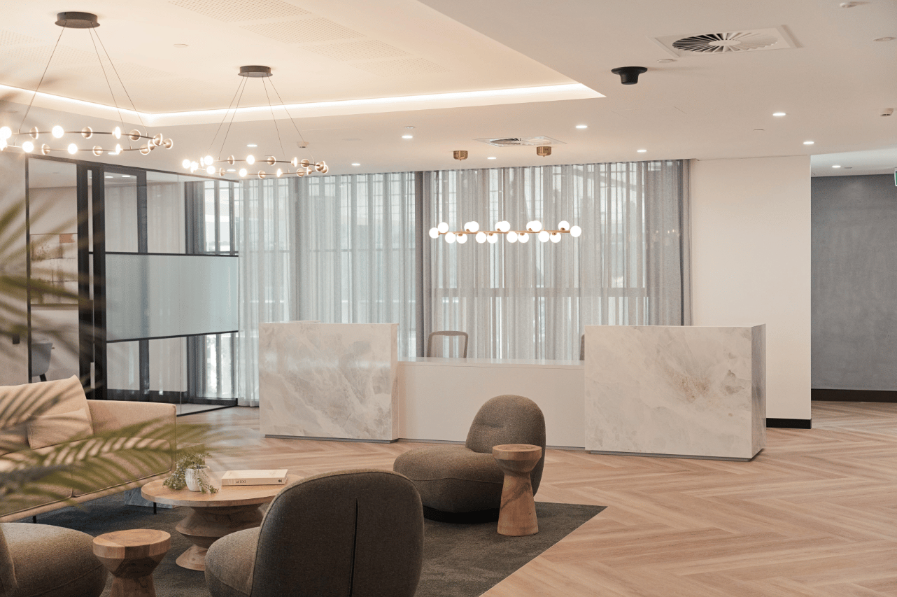 reception desk made from marble and waiting area with pendant lights