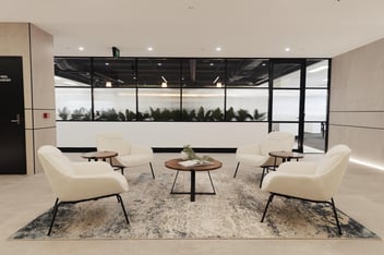 lobby space with rug, 4 chairs and circular table in the middle