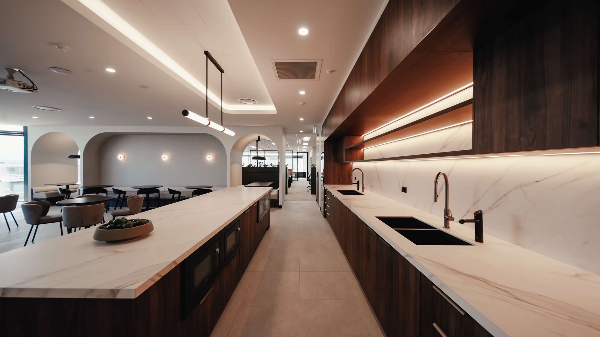 kitchen with dark cabinetry and marble tops