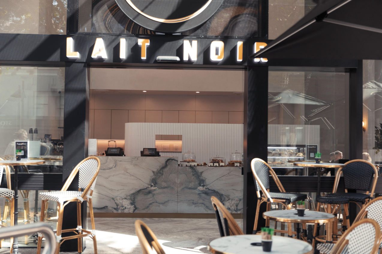 cafe front entrance with sign above lait noir