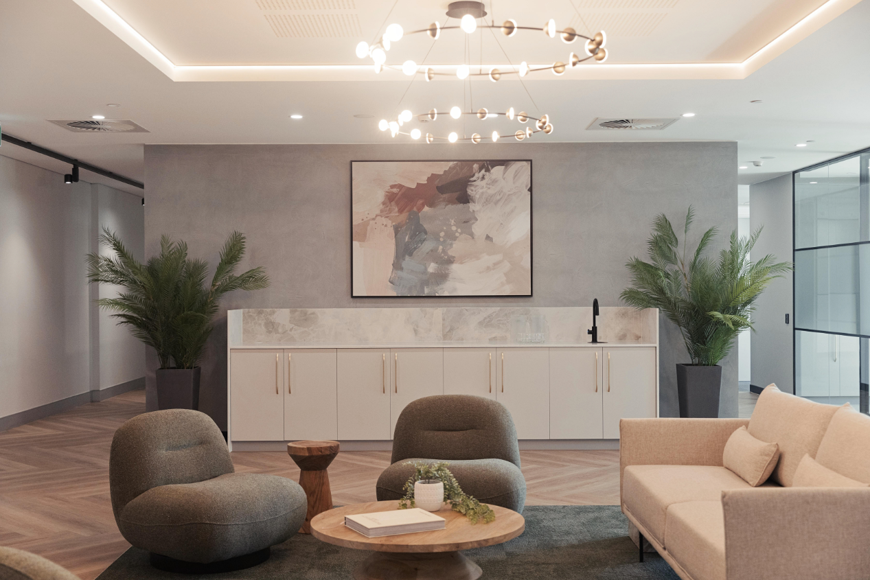 commercial reception waiting area with single sofas and 2 seater sofa, plants, pendant lighting and wall art commercial reception waiting area with single sofas and 2 seater sofa, plants, pendant lighting and wall art