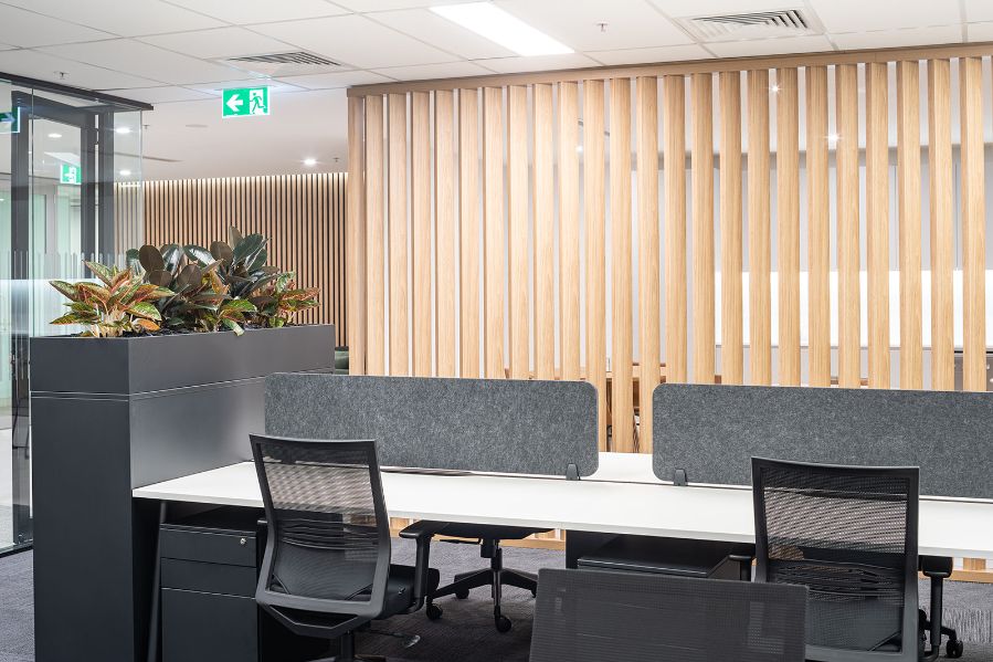 wooden feature wall in an office with workstations