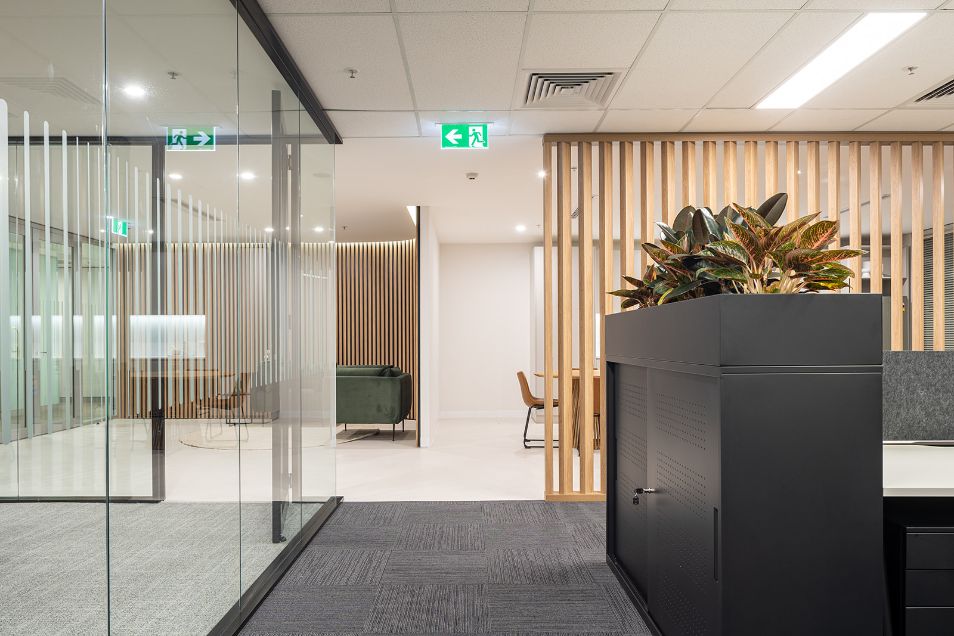 black tambour units in front on the timber slatted room divider