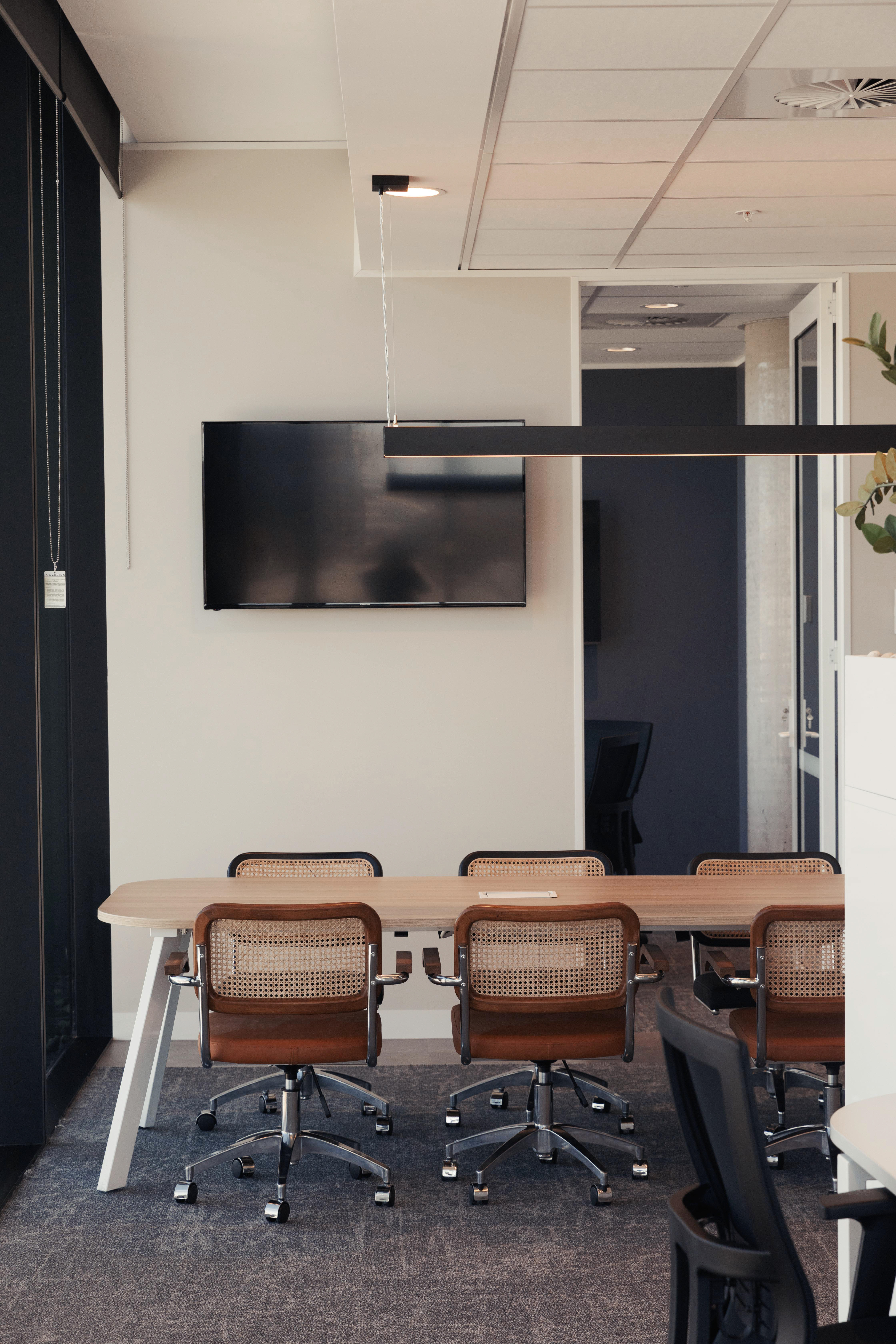 meeting table with brown chairs